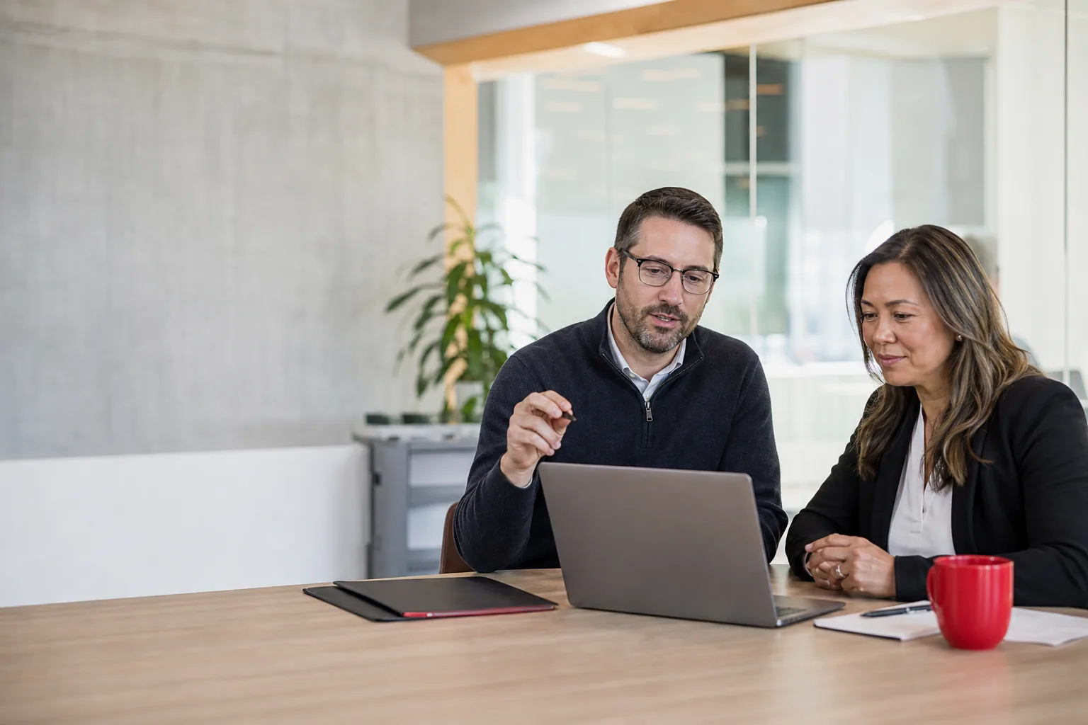 An EZ Support specialist discussing a technology plan with a business leader